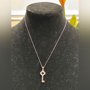 Elegant Silver Key Pendant Necklace
With diamonds.